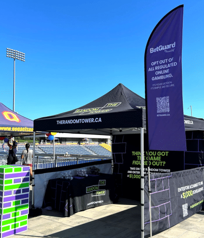 An outdoor booth with a BetGuard flag